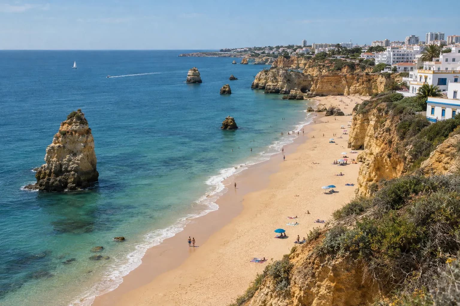 Praia da Rocha in Portimão seen from the cliff top: wide golden sand, rock stacks and the Atlantic